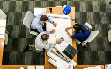 Group of people around a table building a strategic enrollment management plan